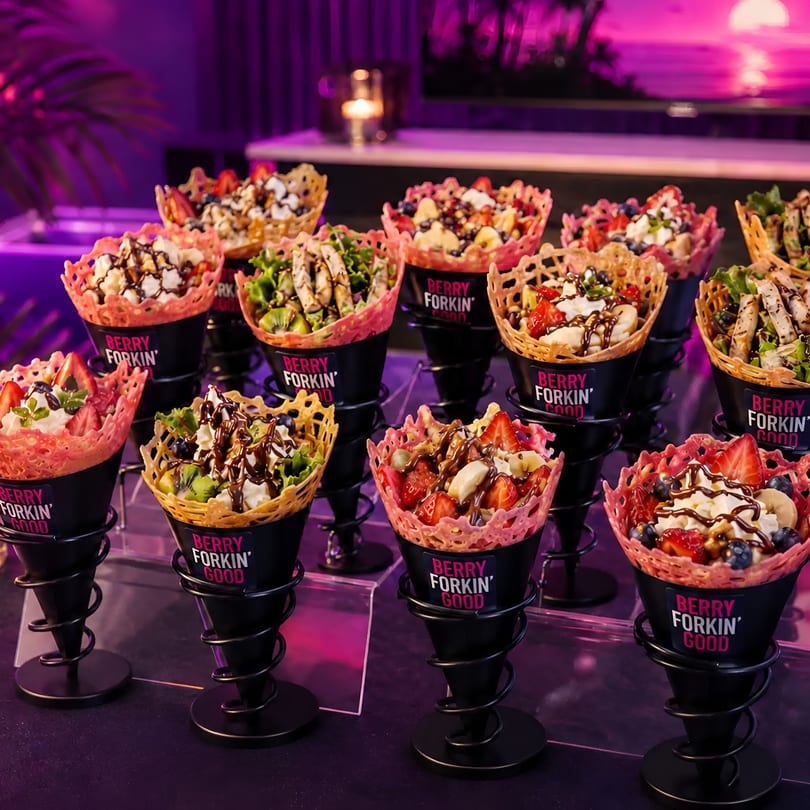 Display of Berry Forkin' Good waffle cones with fruit, cream, and savory fillings.